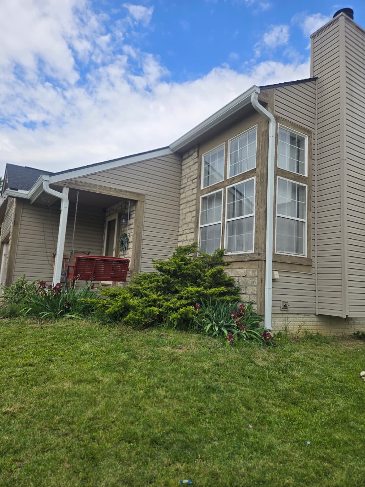 New downspout installation on home siding